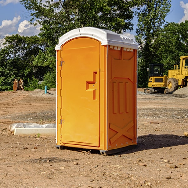 what is the cost difference between standard and deluxe portable restroom rentals in Hartland